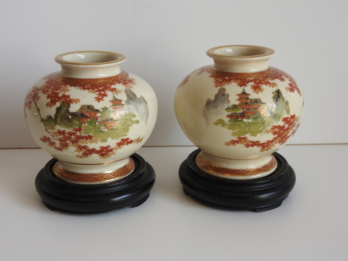 Pair Japanese Satsuma vases on wooden stands c1910